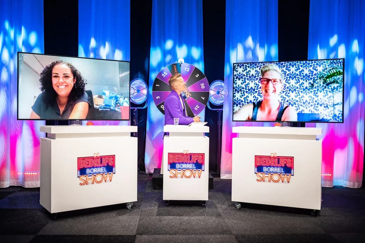 Online Bedrijfsborrel Show met presentator, puntenrad en deelnemers op twee videoschermen